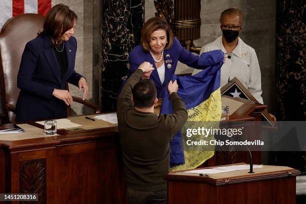 President of Ukraine Volodymyr Zelensky gives a Ukrainian flag signed by members of the Ukrainian military to U.S. Speaker of the House Nancy Pelosi...