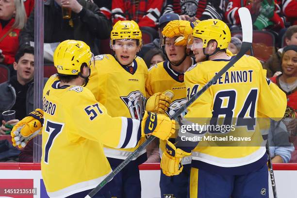 Nino Niederreiter of the Nashville Predators celebrates with teammates after scoring a goal against the Chicago Blackhawks during the first period at...