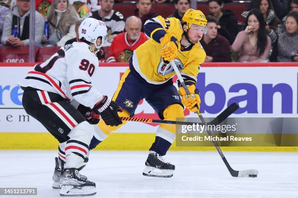 Matt Duchene of the Nashville Predators takes a shot on goal defended by Tyler Johnson of the Chicago Blackhawks during the first period at United...