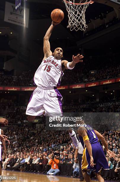 Vince Carter of the Toronto Raptors gets to the basket past two Los Angeles Lakers during a game at the Air Canada Centre in Toronto, Canada. DIGITAL...