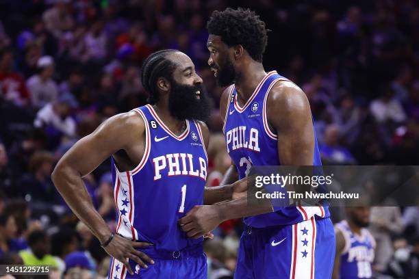 James Harden and Joel Embiid of the Philadelphia 76ers speak during the third quarter against the Detroit Pistons at Wells Fargo Center on December...