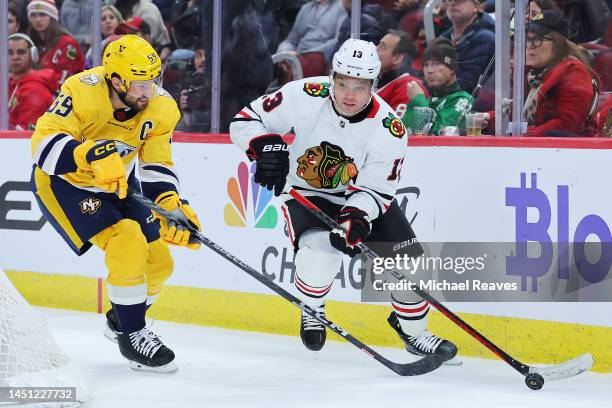 Max Domi of the Chicago Blackhawks skates with the puck against Roman Josi of the Nashville Predators during the second period at United Center on...