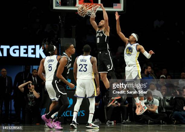 Ben Simmons of the Brooklyn Nets dunks the ball against Draymond Green and Moses Moody of the Golden State Warriors during the second half of the...