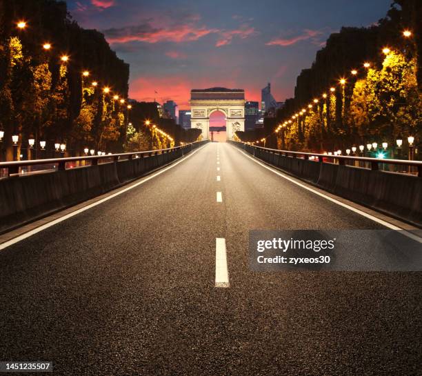 the arc de triomphe on the champs-elysees in paris,france - avenue des champs elysees stock pictures, royalty-free photos & images