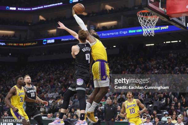 LeBron James of the Los Angeles Lakers dunks the ball against Kevin Huerter of the Sacramento Kings in the second quarter at Golden 1 Center on...
