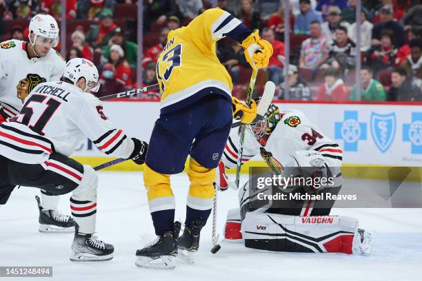 Petr Mrazek of the Chicago Blackhawks makes a save against Yakov Trenin of the Nashville Predators during the third period at United Center on...