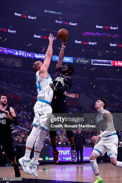 Reggie Jackson of the LA Clippers takes a shot against Mason Plumlee of the Charlotte Hornets in the first half at Crypto.com Arena on December 21,...