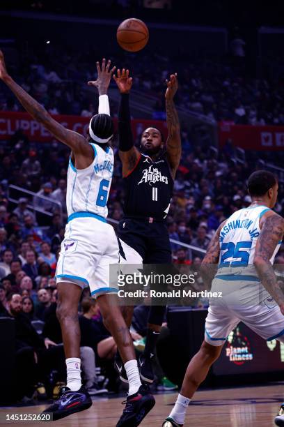 John Wall of the LA Clippers takes a shot against Jalen McDaniels of the Charlotte Hornets in the first half at Crypto.com Arena on December 21, 2022...