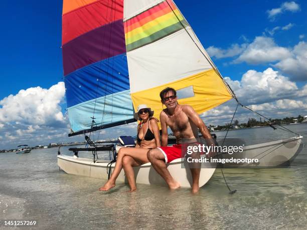 portrait of heterosexual couple on tropical beach - catamaran sailing stock pictures, royalty-free photos & images