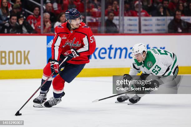 Trevor van Riemsdyk of the Washington Capitals skates with the puck as Wyatt Johnston of the Dallas Stars defends during the third period of the game...