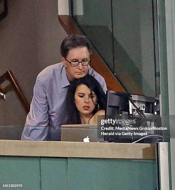 Red Sox owner John Henry rests his head on his wife Linda Pizzuti as the Red Sox take on the White Sox at Fenway. Friday, August 30, 2013.