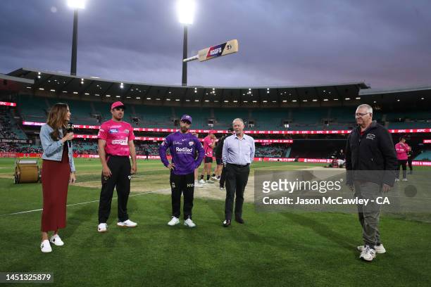 Moises Henriques of the Sixers and Matthew Wade of the Hurricane take part in the bat flip ahead of the Men's Big Bash League match between the...
