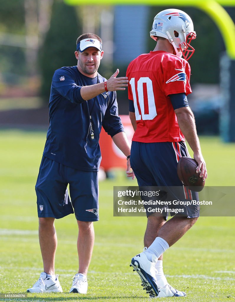(09/04/2016 Foxboro, MA) Offensive coordinator Josh McDaniels pats New England Patriots quarterback Jimmy Garoppolo on the back during practice at Gillette Stadium on Sunday, September 4, 2016. Staff Photo by Matt West