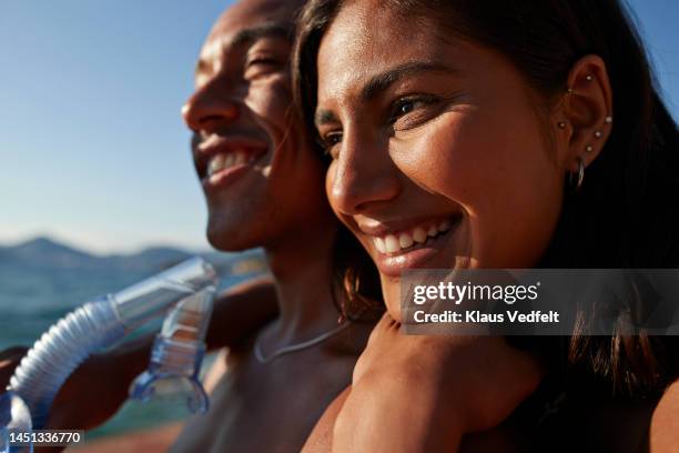 woman leaning head on boyfriend's shoulder - shoulder detail ストックフォトと画像