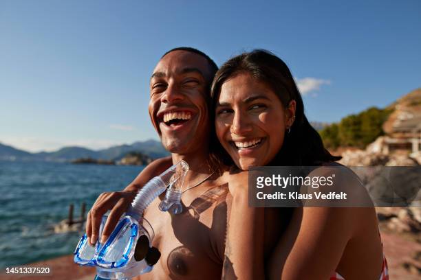 woman with boyfriend holding snorkel and scuba mask - snorkel beach stock pictures, royalty-free photos & images