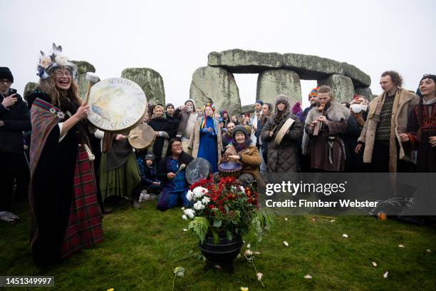 People greet the sunrise at Stonehenge, on December 22 in Amesbury, United Kingdom. The famous historic stone circle, a UNESCO listed ancient...