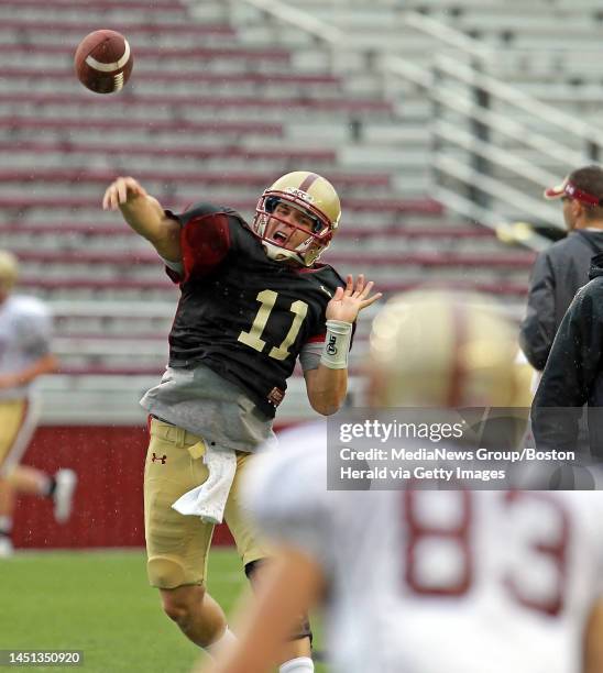 Boston College quarterback Chase Rettig unloads a pass to Boston College wide receiver Alex Amidon as the BC Eagles football team practices in...