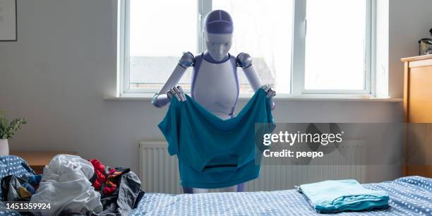 android folding clothes in bedroom - folded tee stock pictures, royalty-free photos & images