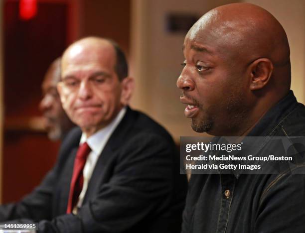 Attorney Mitchell Garabedian, left, listens as he holds a press conference with Gerald Armstrong,far left, the alleged oldest of Red Sox employee...