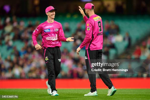 Jordan Silk of the Sixers celebrates with James Vince of the Sixers after taking a catch during the Men's Big Bash League match between the Sydney...