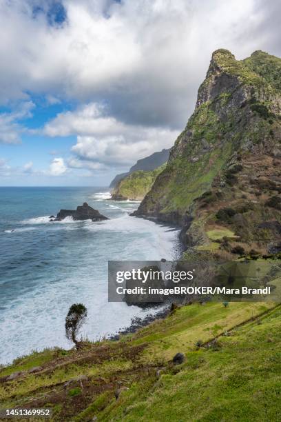 view of steep cliffs and mountains on the coast with sea, enseada de baixo, boaventura, madeira, portugal - vista de baixo para cima fotografías e imágenes de stock