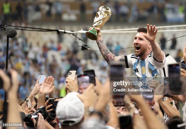 Lionel Messi of Argentina celebrates with the FIFA World Cup Qatar 2022 Winner's Trophy during the FIFA World Cup Qatar 2022 Final match between...