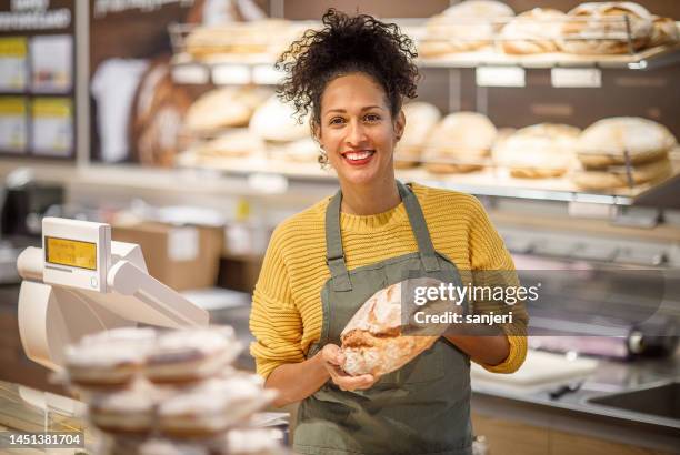 verkäuferin in einer bäckerei - brot einkaufen stock-fotos und bilder