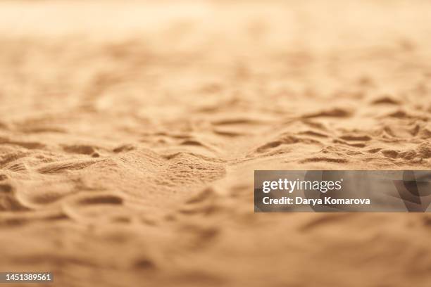 selective focus of sand on the coast, front view of yellow sand with a copy space. - areia - fotografias e filmes do acervo