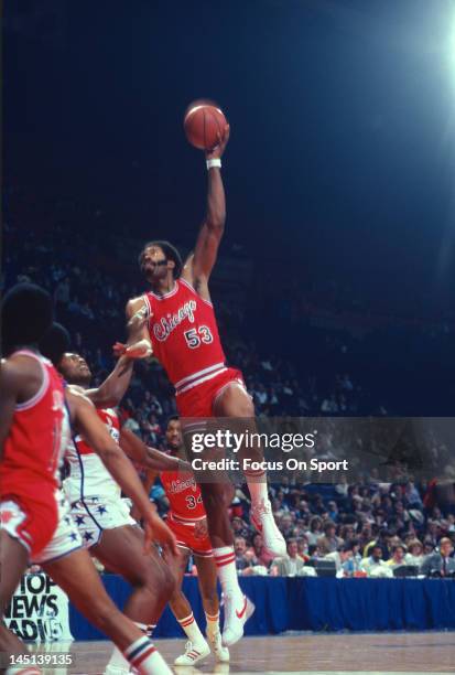 Artis Gilmore of the Chicago Bulls shoots over Rick Mahorn of the Washington Bullets during an NBA basketball game circa 1981 at the Capital Centre...