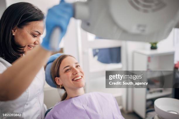 young woman at the dentist - dentista imagens e fotografias de stock