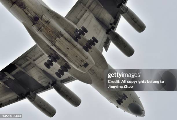 close up view of a russian made il 76 transport plane landing overhead at chengdu shuangliu airport - chengdu stock pictures, royalty-free photos & images