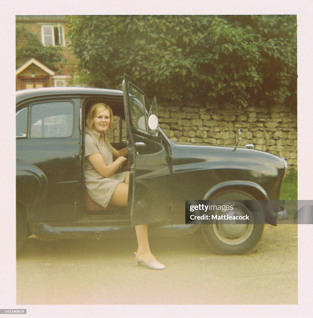Female sitting in retro car