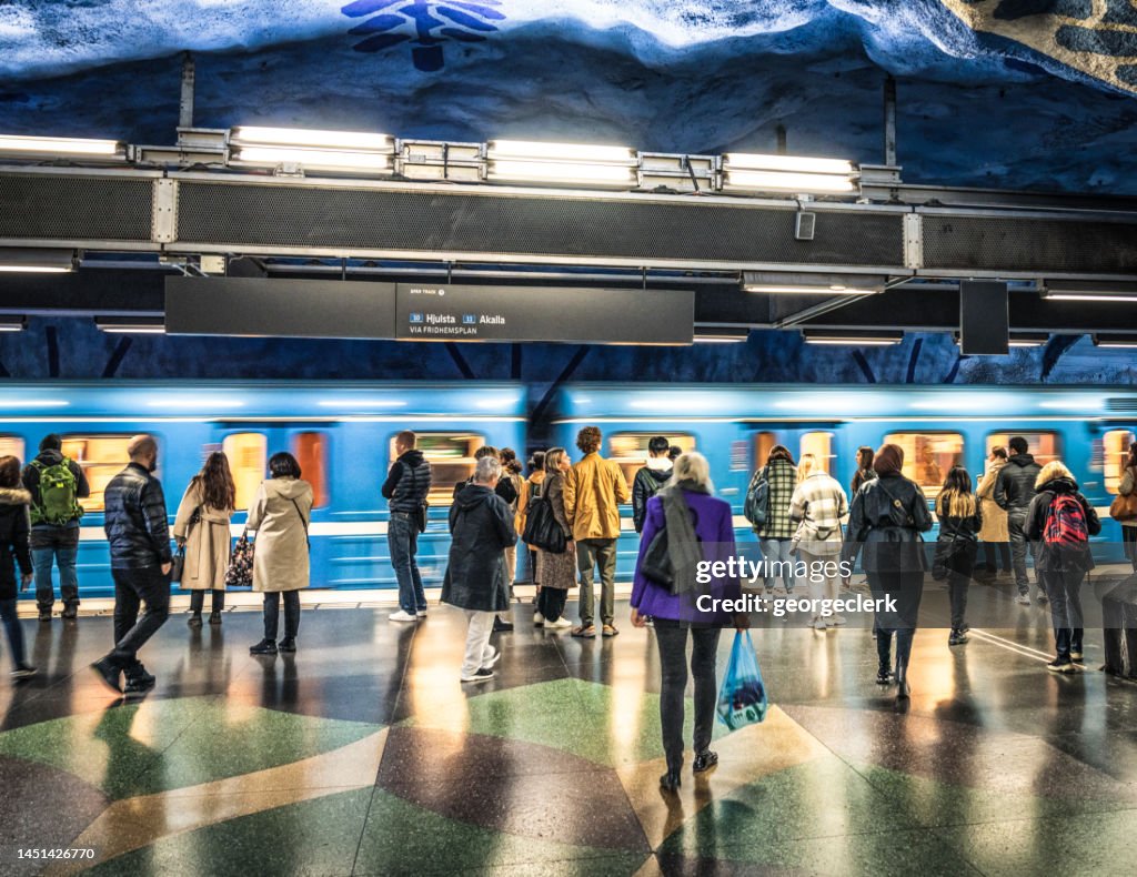 Passengers waiting to board subway train