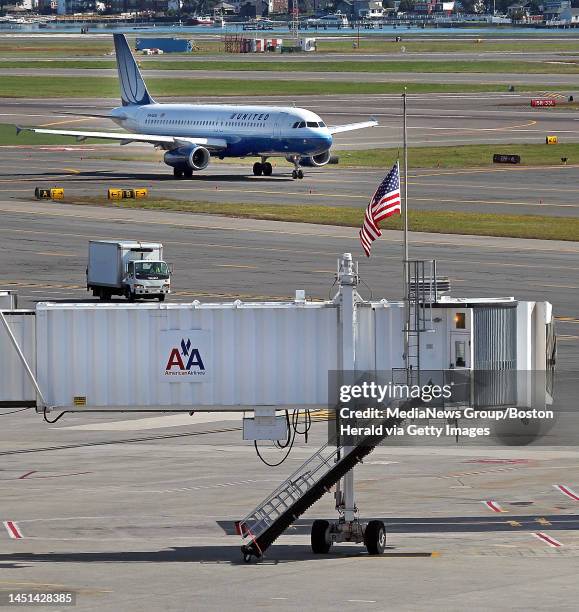 Boston, MA)A flag flies at half staff over the jetway where American Airlines Flight 11 left 10 years ago on it's deadly flight. A United Airline...