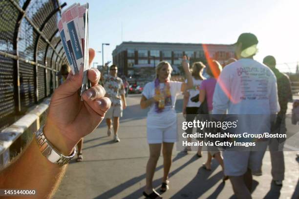 Scalpers and Concert goers with extra tickets attempt to sell their wares prior to the Jimmy Buffet Concert at Fenway Park, 9/12/04.