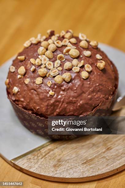 panettone with chocolate and hazelnut icing - iced fruit cake stock pictures, royalty-free photos & images