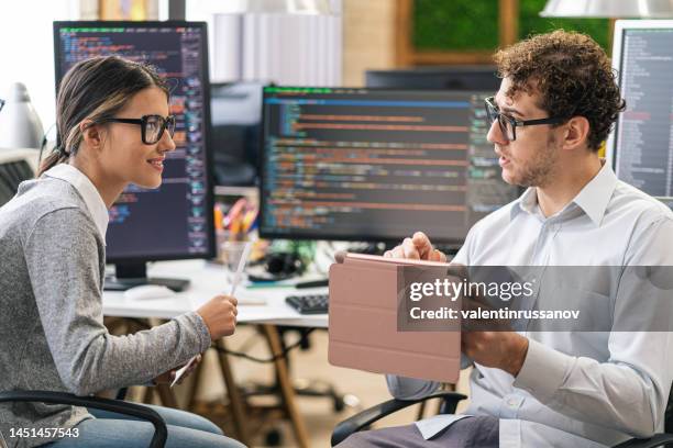 software programmers analyzing html code and database, brainstorming script ideas to develop new security system. engineers working with coding language collaborating on group project. - development and coding stockfoto's en -beelden