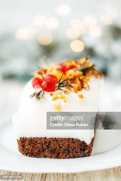 xmas cake against blurred holiday lights. - christmas dessert stock pictures, royalty-free photos & images