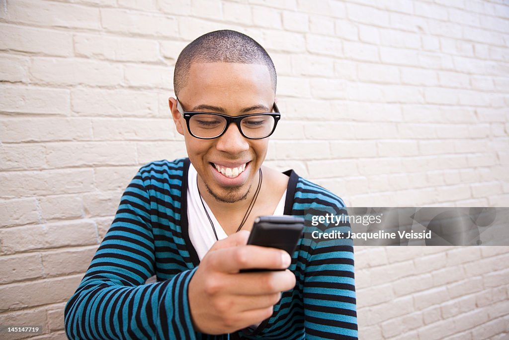 Man Using Mobile Device Hip Young Man Using Mobile Device High-Res Stock Photo - Getty Images