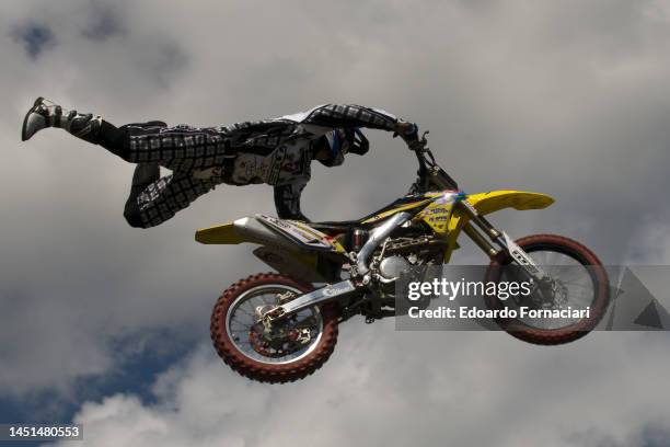 View, from below, as an unidentified racer jumps during a freestyle Motocross exhibition, Sorbolo, Italy, May 8, 2010.