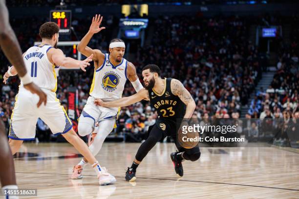 Fred VanVleet of the Toronto Raptors dribble against Klay Thompson and Moses Moody of the Golden State Warriors during the second half of their NBA...