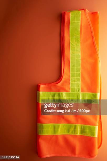 orange color reflective waist coat against orange background,malaysia - rock bildbanksfoton och bilder