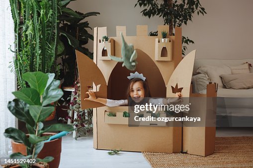 Little girl playing with handmade castle