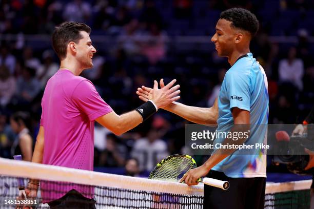 Felix Auger-Aliassime of Kites shakes hands after defeating Dominic Thiem of Hawks during day four of the World Tennis League at Coca-Cola Arena on...