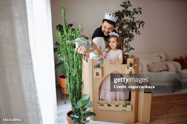 father playing exciting adventure game with daughter - princess castle stock pictures, royalty-free photos & images