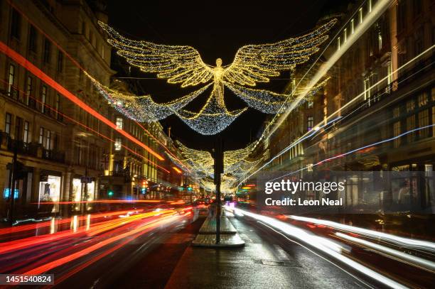 Illuminated Christmas angels are suspended above the Regent Street shopping district on December 22, 2022 in London, England. After November's retail...