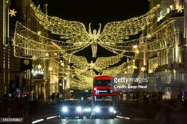Illuminated Christmas angels are suspended above the Piccadilly Circus shopping district on December 22, 2022 in London, England. After November's...