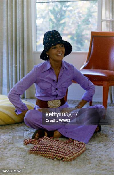 Actress Ali MacGraw sits on rug and answers questions during an interview in her friend's apartment.