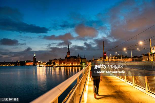 solo traveler walking stockholm empty streets at night - man silhouette back lit stock pictures, royalty-free photos & images