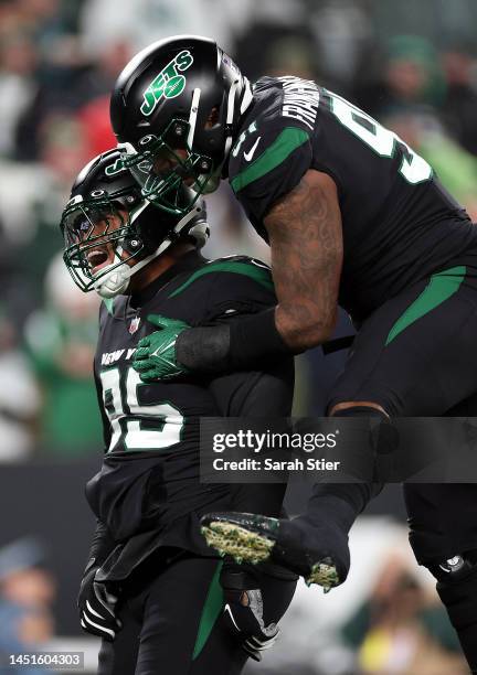 Quinnen Williams of the New York Jets is congratulated by John Franklin-Myers after sacking quarterback Trevor Lawrence of the Jacksonville Jaguars...